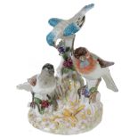 A Continental porcelain group of three birds on a stump, late 19th century  A Continental