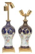 A pair of French porcelain and Italian gilt metal mounted table lamps  A pair of French porcelain