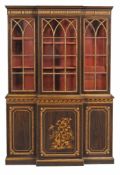 A simulated rosewood and parcel gilt breakfront bookcase in Regency style  A simulated rosewood