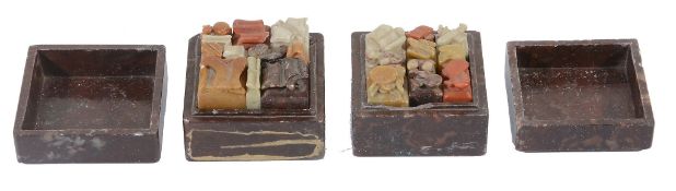 A Chinese carved stone set of boxed desk seals, in various colours  A Chinese carved stone set of