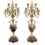 A pair of Continental gilt metal mounted marble six light candelabra, late 19th century, each with