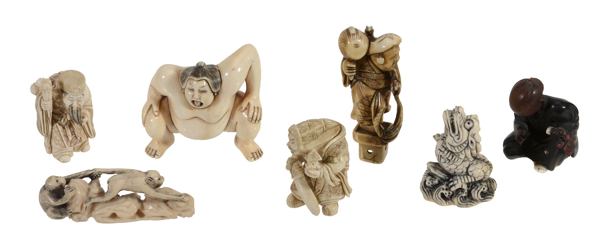 An Ivory Netsuke of a sage leaning on a staff and stroking his beard  An Ivory Netsuke   of a sage