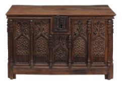 A Gothic oak coffer, 16th century and later, with a rectangular plank top  A Gothic oak coffer, 16th