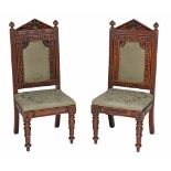 A near pair of early Victorian carved oak and upholstered side chairs  A near pair of early