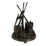 A French patinated bronze desk stand modelled as a military trophy  A French patinated bronze desk