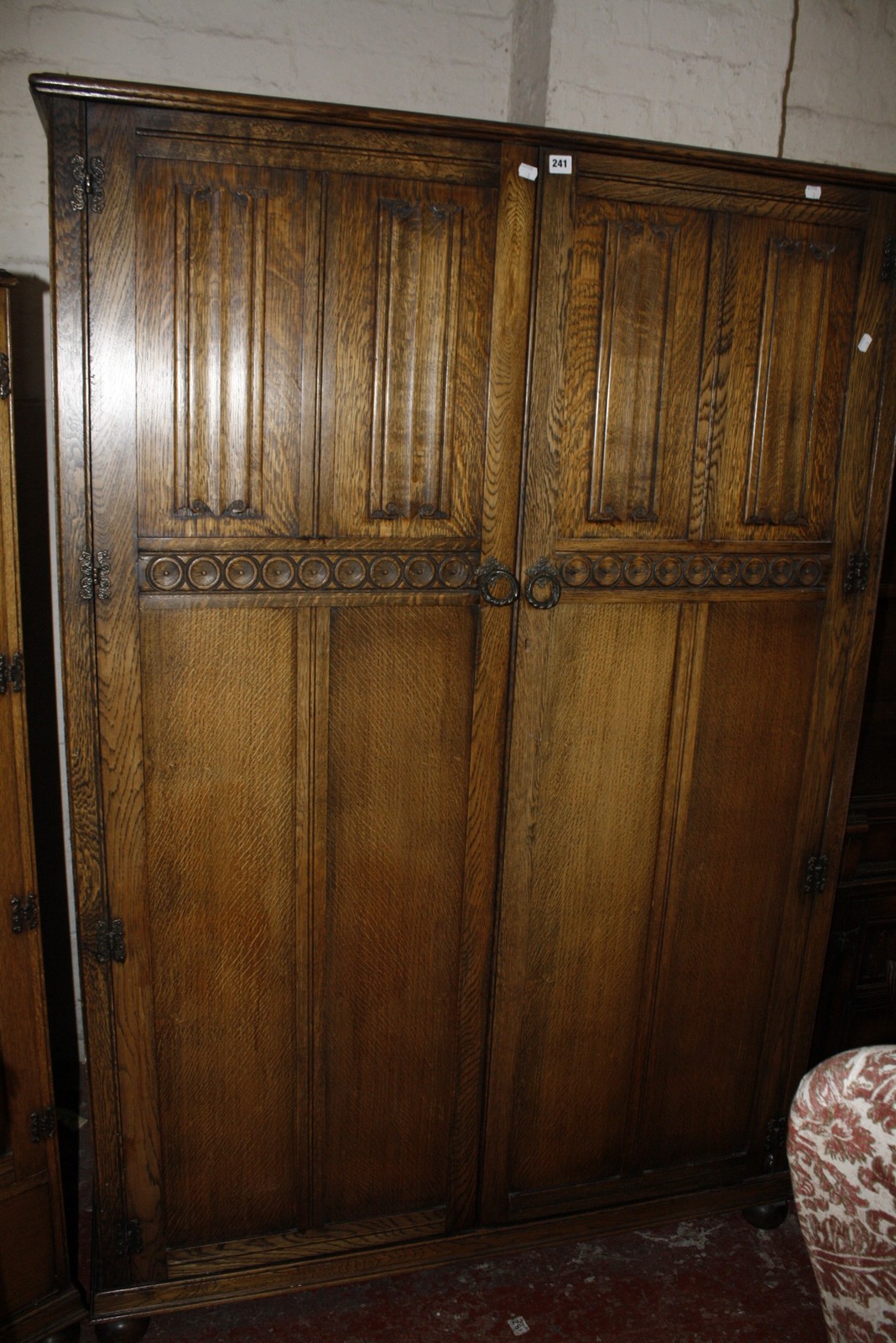 Two oak linen fold panelled wardrobes and a headboard. Best Bid