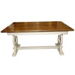 An oak refectory table with a painted trestle base, used for shop display.