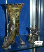 A bronze figure of a putto slaying a dragon, 12cm high and a green glass and bronze mounted flower