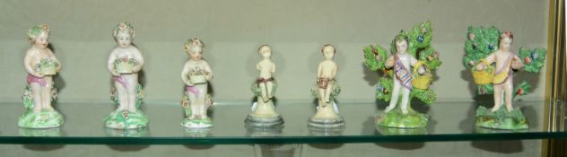 Two pearlware putti, 11.5cm high, three Derby putti, two 11cm high and one 9cm high and two others