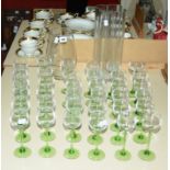 Two modern clear glass vases and a quantity of green stemmed hock glasses