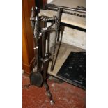 A steel fire iron companion stand and beech bellows, plus a cast and wrought iron dog grate with