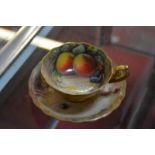 A Royal Worcester teacup and a saucer, painted with Autumnal fruit and signed by W. H. Austin and T.