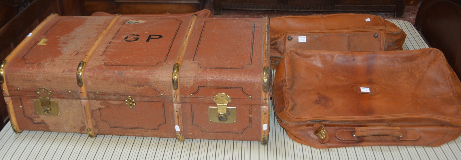 A canvas and brass mounted travelling trunk, together with three leather suitcases -4