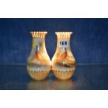 A pair of Royal Worcester pear shaped vases, painted with pheasants and signed by Jas. Stinton,