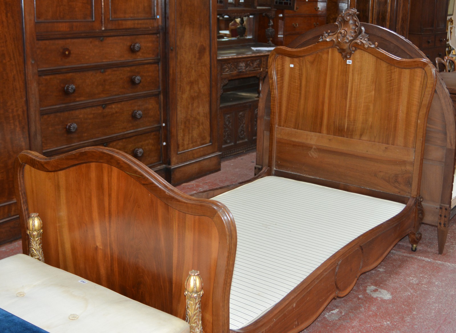 A walnut framed single bed in Louis XV style 146cm high, 207cm length