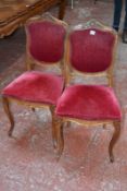 A set of six French walnut and upholstered armchairs