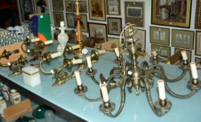 A 20th Century brass eight light electrolier, a set of four brass twin light wall appliqués, a