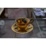 A Royal Worcester coffee cup and saucer, painted with Autumnal fruit and signed by W.Hale, date code