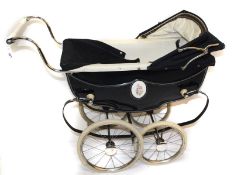 A 1950s Sol Whitby Marmot pram, with hood, apron, inner leather straps and fold down front; a