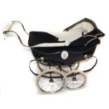 A 1950s Sol Whitby Marmot pram, with hood, apron, inner leather straps and fold down front; a