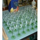 A Dartington glass vase (boxed) and a quantity of green stemmed hock glasses (in boxes)