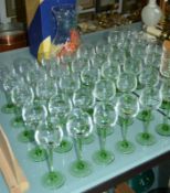A Dartington glass vase (boxed) and a quantity of green stemmed hock glasses (in boxes)