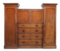 A William IV mahogany compactum, circa 1835, the central bookcase section enclosed by moulded