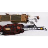 A set of vintage golf clubs within a canvas bag, labelled 'A Douglas Product, Made in England';