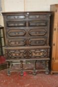 A 17th Century style oak chest on stand, with five long moulded drawers on stand with turned
