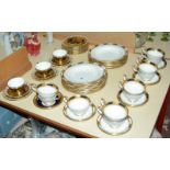Nine Aynsley 'Empress Cobalt' teacups and seven saucers with gilt rim decoration, Aynsley '