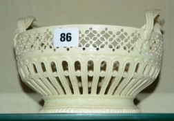 A Leeds pottery creamware two-handled basket, circular, pierced decoration with entwined handles,