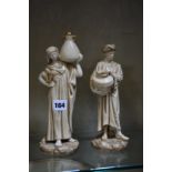 A pair of Royal Worcester figures of the Cairo Water Carriers, modelled by James Hadley in blush