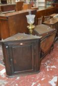 A Georgian oak corner hanging cabinet, a clerks desk and a brass oil lamp.