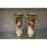 A pair of Royal Worcester trumpet vases painted with roses and signed by K. Blake and M.Hunt, 20cm