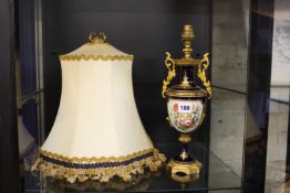 A Sevres style vase painted with Watteauesques and fitted for electricity as a lamp