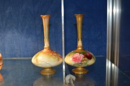 A pair of Royal Worcester vases painted with roses, of compressed globular form with tall slender