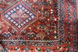 Two Shiraz rugs and a Caucasian rug, 20th Century