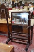 An early Victorian mahogany cheval mirror, with a rectangular frame on turned supports
