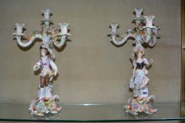 A pair of German porcelain (Plaue) flower encrusted figural four-light candelabra, 40cm high