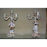 A pair of German porcelain (Plaue) flower encrusted figural four-light candelabra, 40cm high