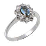 An aquamarine and diamond cluster ring, the central oval shaped aquamarine...  An aquamarine and