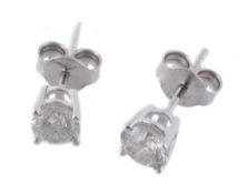 A pair of diamond ear studs, the brilliant cut diamond, in a four claw setting  A pair of diamond