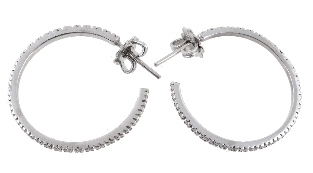 A pair of diamond ear hoops, the hoops set with brilliant cut diamonds  A pair of diamond ear hoops,