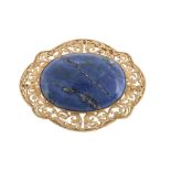 A lapis lazuli brooch, the central oval cabochon lapis lazuli within a...  A lapis lazuli