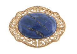 A lapis lazuli brooch, the central oval cabochon lapis lazuli within a...  A lapis lazuli