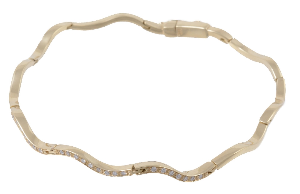 An 18 carat gold articulated diamond bracelet, the polished wavy panels  An 18 carat gold