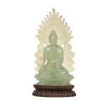 A jade figure of Buddha Shakyamuni  , seated in dhyanasana with his hands in bhumisparshamudra, on