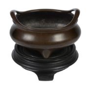 A Chinese bronze tripod censer, 18th/19th century  , of compressed form with outswept pierced