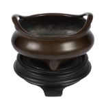 A Chinese bronze tripod censer, 18th/19th century  , of compressed form with outswept pierced