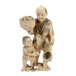 A Japanese Ivory Okimono Group   of a fisherman and his son, the former holds a net in one hand and